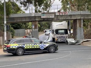 Traffic delays as truck hits overpass