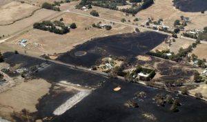 Storms ease, fire crews battle blaze in the west